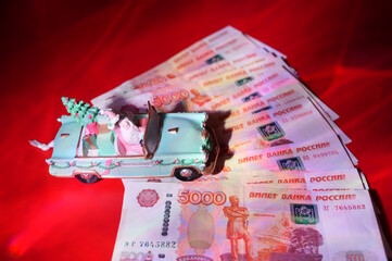 A toy car with Santa and Russian rubles. Finance and economics.