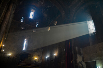Monastery interior. An old lamp in the church. Sunlight streaming through the windows. Christianity and religion.