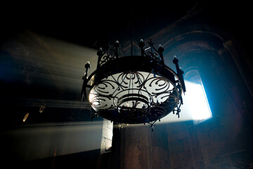Monastery interior. An old lamp in the church. Sunlight streaming through the windows. Christianity and religion.