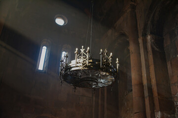 Monastery interior. An old lamp in the church. Sunlight streaming through the windows. Christianity and religion.