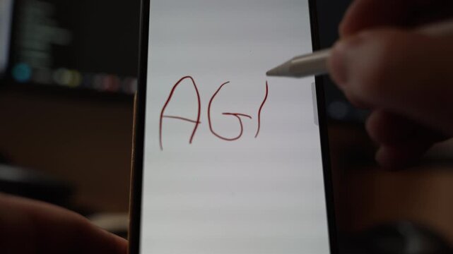 Close view of the acronym AGM handwritten with a stylus on a smartphone screen showing digital note taking concept modern communication and business or learning interaction in an indoor setting
