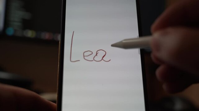Close view of the word Learn handwritten on a smartphone screen using finger drawing showing digital education concept creativity and modern learning interaction in an indoor setting