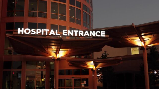 Hospital Entrance with Signage. Emergency Sign at Hospital in USA. Emergency Room and Medical Care Building. Hospital, Medical Center, Emergency Room. Evening Night Times.