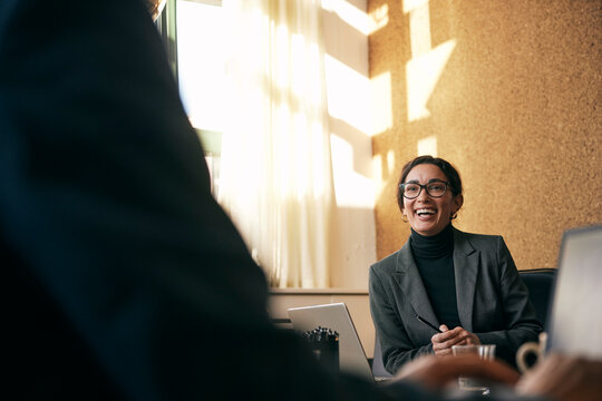 Happy female financial advisor communicating in meeting at law firm