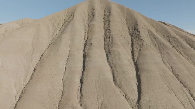 Aerial view of the stark, arid landscape of Calanchi del Cannizzola, etched with deep gullies and earthy tones, creating a dramatic scene, Centuripe, Sicilia, Italy.