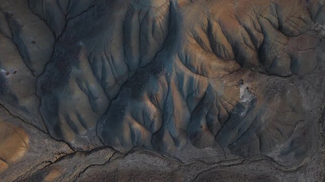 Aerial view of the textured landscape with contrasting colors, displaying the unique geological formations of Calanchi del Cannizzola, Centuripe, Sicilia, Italy.