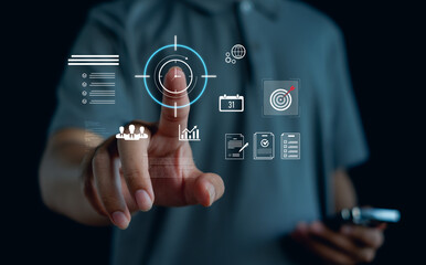 Businessman touching virtual target interface with digital icons for analytics, planning, documents and growth, representing data driven strategy, modern technology and productivity management.