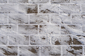 Top view photo of snow on sidewalk paving slabs in the sunny winter morning. Winter clean snow on pavement background texture on cold day.