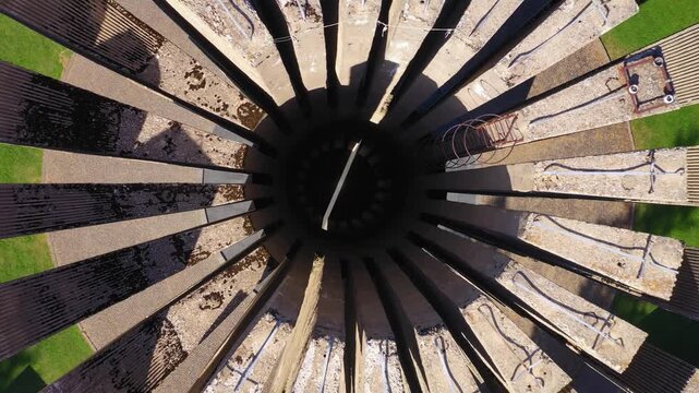 Abstract industrial structure with radial metal beams and central opening