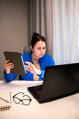 Online business owner managing her e-commerce store from home. Entrepreneur analyzes data on computer screen in home setting. Modern reality of running successful digital business remotely