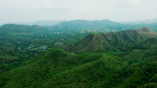 4K Aerial shot of Aravalli range as seen from Rayta in Udaipur, Rajasthan. Green forest on Aravalli Hills. Travel and holidays background. Lush green hills of Aravalli Range. Ecosystem in nature conce