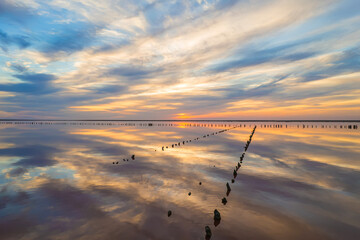 Golden sunset over calm reflective salt lake