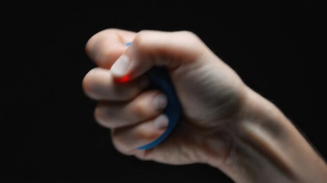 Anxious Hand Squeezing a Stress Ball Indicating High Cortisol Hormone Levels and Nervous Tension