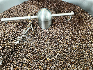 Freshly roasted coffee beans cooling inside an industrial coffee roasting drum, showing texture, aroma, and production process for specialty coffee, food industry, and artisanal roasting concepts