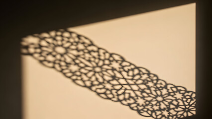 Delicate Lattice Shadow Pattern Cast on a Soft Neutral Wall by Filtered Light in a Calm Interior Space