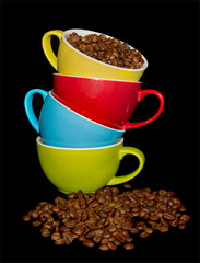 Colorful cups with coffee beans