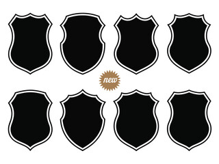 Collection of eight varied black shield emblems for graphic design projects.