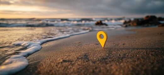 Golden-yellow location pin stands on a sandy beach, the ocean waves gently reach shore at sunset