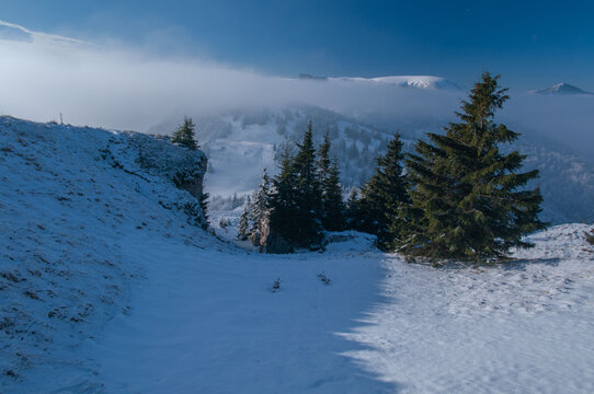 View of snow-covered peak where the crisp air bites and the sun kisses the frosted pines, nestled in a winter wonderland, Velka Fatra, Zilina Region, Slovakia.