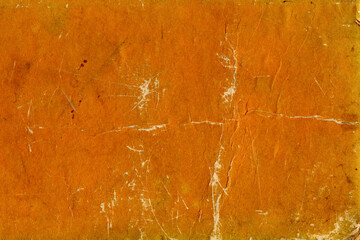 Orange grunge paper texture with aged scratches.