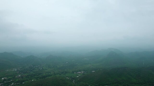 4K aerial view of Rayta Hills at Udaipur, Rajasthan, India. Green mountains and cloudy sky during monsoon season. Travel and holidays background. Lush green hills of Aravalli Range. Protect ecology, s