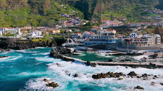 Powerful Atlantic Ocean waves crashing into natural lava pools along the volcanic coastline of Porto Moniz on Madeira Island