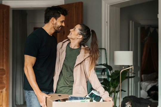Smiling woman spending quality time with man at new home