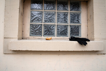 Black gloves on public bathroom window sill