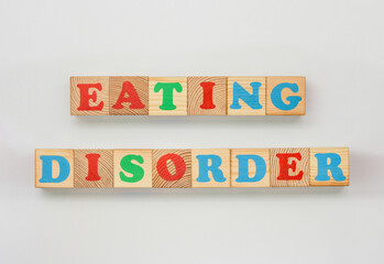Painted alphabet blocks arranged to spell Eating disorder