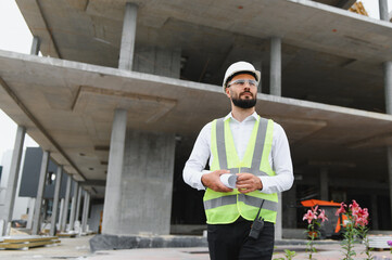 Engineer in hard hat at building construction site