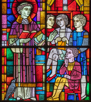 BERN, SWITZERLAND - JUNY 27, 2022:  St. Vincent de Paul  on the stained glass in the church Dreifaltigkeitskirche by Albin Schweri and made by C. Reich 1939