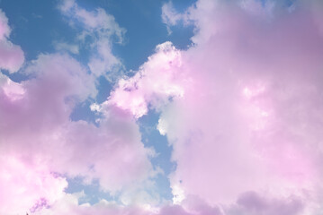 Dreamy and fantasy pink clouds at the blue sky with pastel tones