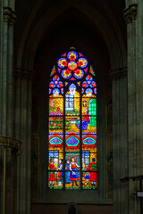 Beautiful old colourful stained glass window with the inscription Donated by the Parish Community (Gewidmet Von Der Pfarr Gemeinde) in the 1879 Votive Church, Vienna, Austria
