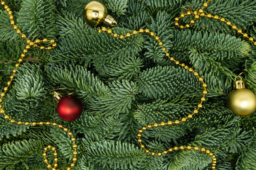 Evergreen Fir Branches with Golden Garland and Christmas Ornaments Flat Lay Background