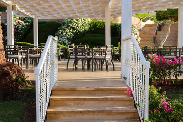 A beautiful wooden staircase in an outdoor restaurant.