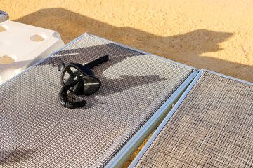 diving mask left on hotel sunbed.