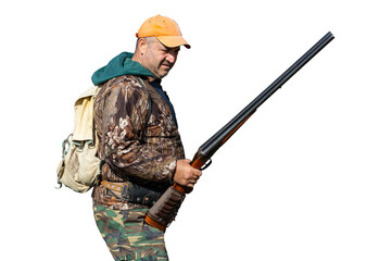 A hunter with a gun in camouflage clothing. A senior man with a gun, medium shot, searching for game.