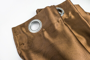 Metal eyelets on brown velvet curtains with a cage decoritive finial