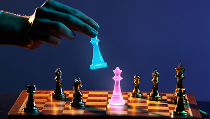 Hand lowering glowing cyan chess king during critical move. Concept of calculated risk, gambling...