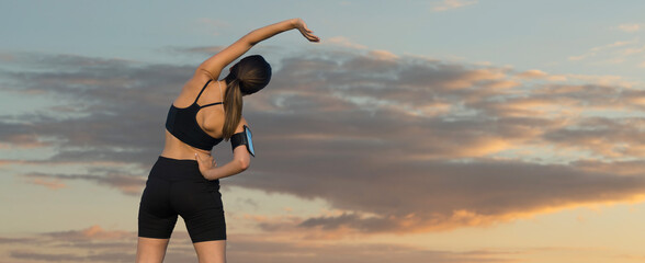 Young attractive woman doing exercise working out outdoors.