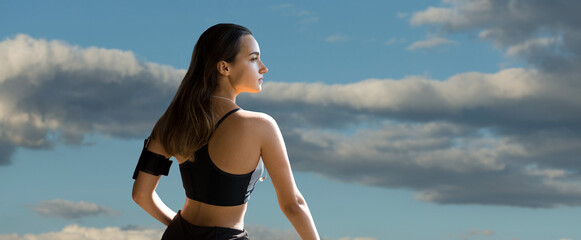 A young slim athletic girl in sportswear with snakeskin prints performs a set of exercises. Fitness and healthy lifestyle.