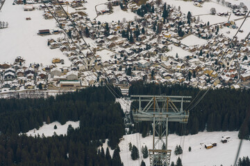 Ski lift high above snow covered grindelwald village klosters