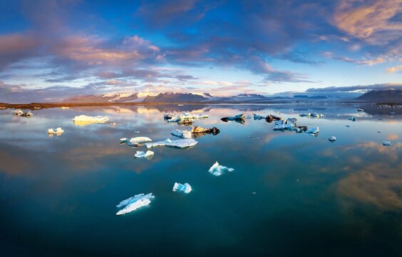 droen view of the icebergs and the Jokulsarlon Glacier lagoon with Vatnajokull Glacier in the background at sunrise