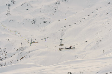 Ski resort with chairlifts transporting people up snowy mountain in klosters