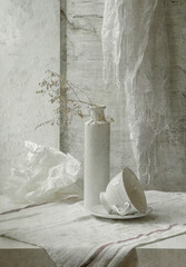 Still life with white dishes on a light background