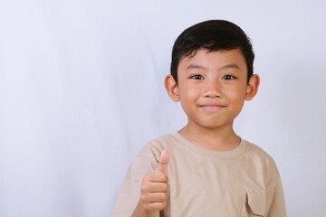 Asian boy looking at the camera against a clean white background, suitable for childhood, identity, and education related concepts.