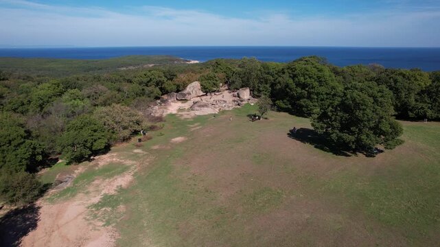 Aerial view of Beglik Tash, where the ancient sanctuary meets the sea, contrasting lush forests with the azure horizon, Primorsko, Burgas, Bulgaria.