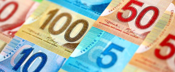 Obraz premium Canadian Dollar currency money bills. CAD currency banknotes in big amount with different denomination close up