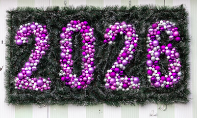 Christmas decor ornaments made from purple bulbs on green grass showing celebration of 2026