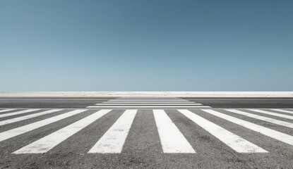 Road markings and a clear sky meet on an empty street, simple and serene